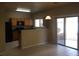 Kitchen with dark countertops, wood cabinets and a breakfast nook at 2636 S Sailors Way, Gilbert, AZ 85295