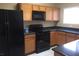 Kitchen with black appliances and dark countertops at 2636 S Sailors Way, Gilbert, AZ 85295