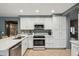 Bright kitchen featuring white cabinets, an island, and tile flooring at 2871 S Los Altos Pl, Chandler, AZ 85286