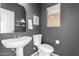 Stylish powder room with dark gray walls and gold accents at 30052 N Desert Willow Blvd, San Tan Valley, AZ 85143