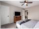 Bedroom with a bed, TV, dresser, and ceiling fan at 30052 N Desert Willow Blvd, San Tan Valley, AZ 85143