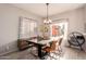 Dining room with a large table, modern chandelier, and backyard access at 30052 N Desert Willow Blvd, San Tan Valley, AZ 85143