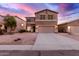 Two-story house with a large driveway and landscaped front yard at 30052 N Desert Willow Blvd, San Tan Valley, AZ 85143