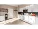 Modern kitchen with white cabinets, stainless steel appliances, and a dark tile backsplash at 30052 N Desert Willow Blvd, San Tan Valley, AZ 85143