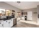 Modern kitchen with white cabinets, a large island, and access to the backyard at 30052 N Desert Willow Blvd, San Tan Valley, AZ 85143