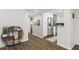 Bright hallway with a stylish wooden shelving unit and view of kitchen at 3655 N 5Th Ave # 115, Phoenix, AZ 85013