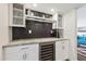 Stylish wet bar featuring granite countertops and dark tile backsplash at 3655 N 5Th Ave # 115, Phoenix, AZ 85013