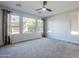 Well-lit bedroom with ample natural light and plush carpeting at 392 E Laddoos Ave, Queen Creek, AZ 85140