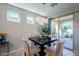 Elegant dining room with a modern chandelier and patio access at 392 E Laddoos Ave, Queen Creek, AZ 85140