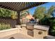 Built-in outdoor grill with pergola cover at 392 E Laddoos Ave, Queen Creek, AZ 85140