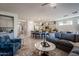 Open living room showcasing a sectional sofa and views into the kitchen at 392 E Laddoos Ave, Queen Creek, AZ 85140