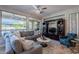 Spacious living room featuring a cozy corner sofa and large windows at 392 E Laddoos Ave, Queen Creek, AZ 85140