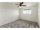 Neutral bedroom with carpet, ceiling fan, and a bright window at 4306 E Frye Rd, Phoenix, AZ 85048