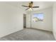 Bright bedroom featuring a ceiling fan, window view, neutral walls, and plush gray carpet at 4306 E Frye Rd, Phoenix, AZ 85048