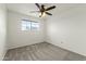 Neutral bedroom with carpet, ceiling fan, and a bright window at 4306 E Frye Rd, Phoenix, AZ 85048