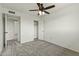 Bright bedroom with ceiling fan, closet, neutral walls, and plush gray carpet at 4306 E Frye Rd, Phoenix, AZ 85048