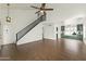 Bright living room featuring hardwood floors, a staircase, and a stylish ceiling fan at 4306 E Frye Rd, Phoenix, AZ 85048