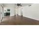 Bright living room with wood floors, ceiling fan, and access to the kitchen area at 4306 E Frye Rd, Phoenix, AZ 85048