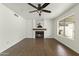 Spacious living room showcasing a traditional fireplace, wood floors, and a ceiling fan at 4306 E Frye Rd, Phoenix, AZ 85048