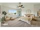 Well-lit main bedroom featuring a sitting area, large windows, and neutral decor at 4306 E Frye Rd, Phoenix, AZ 85048