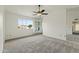 Well-lit main bedroom features carpet, a ceiling fan, and mirrored closet doors at 4306 E Frye Rd, Phoenix, AZ 85048