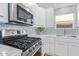 Modern kitchen with gas cooktop and stylish backsplash at 5210 W Jupiter N Way, Chandler, AZ 85226