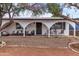 House exterior featuring a covered patio, seating area, and landscaping at 5546 W Encanto Blvd, Phoenix, AZ 85035