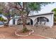 Ranch-style home with a landscaped front yard and seating area at 5546 W Encanto Blvd, Phoenix, AZ 85035