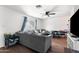 Living room with gray sectional sofa and board games at 5546 W Encanto Blvd, Phoenix, AZ 85035