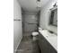 Updated bathroom features a step-in shower, sleek gray cabinetry, and modern fixtures at 5839 E Norwood St, Mesa, AZ 85215