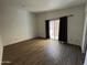 Bright bedroom featuring wood-look flooring, a sliding glass door and updated windows at 5839 E Norwood St, Mesa, AZ 85215