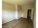 Neutral bedroom with wood-look flooring and a walk-in closet at 5839 E Norwood St, Mesa, AZ 85215