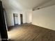Spacious bedroom with wood-look flooring and a double-door closet for ample storage at 5839 E Norwood St, Mesa, AZ 85215