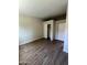 Bedroom featuring wood-look flooring, neutral paint, and a closet at 5839 E Norwood St, Mesa, AZ 85215