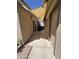 An exterior view of the home reveals a sheltered walkway leading to the backyard at 5839 E Norwood St, Mesa, AZ 85215