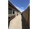 The exterior features a private walkway with planters and access to the backyard at 5839 E Norwood St, Mesa, AZ 85215