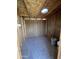 A shed interior with plywood walls and a skylight offers additional storage space at 5839 E Norwood St, Mesa, AZ 85215