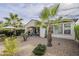 Backyard view showcasing a patio, gravel landscaping, and palm trees at 72 E Camellia Way, Queen Creek, AZ 85140