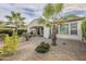 Backyard view showcasing a patio, gravel landscaping, and palm trees at 72 E Camellia Way, Queen Creek, AZ 85140