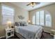 Spacious bedroom with arched window and ceiling fan at 72 E Camellia Way, Queen Creek, AZ 85140