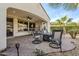 Covered patio with seating area, adjacent to the house at 72 E Camellia Way, Queen Creek, AZ 85140