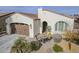 Front view of charming house with two-car garage and landscaping at 72 E Camellia Way, Queen Creek, AZ 85140