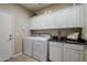 Laundry room with washer, dryer, and cabinets at 72 E Camellia Way, Queen Creek, AZ 85140