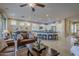 Open concept living room with kitchen views and a ceiling fan at 72 E Camellia Way, Queen Creek, AZ 85140