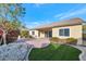 Backyard view of home with covered patio and landscaping at 7873 W Fetlock Trl, Peoria, AZ 85383