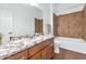 Bathroom with granite countertop and bathtub at 7873 W Fetlock Trl, Peoria, AZ 85383