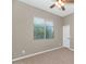 Well-lit bedroom featuring a ceiling fan and large window at 7873 W Fetlock Trl, Peoria, AZ 85383