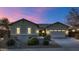 Single-story house with a two-car garage and desert landscaping at 7873 W Fetlock Trl, Peoria, AZ 85383