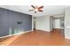 Living room with tile floors, a gray accent wall and ceiling fan at 7873 W Fetlock Trl, Peoria, AZ 85383