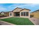 Home exterior and backyard with artificial turf and patio at 8537 E Leland St, Mesa, AZ 85207